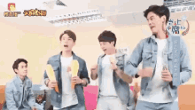 a group of men are dancing in a room with chinese writing on the wall
