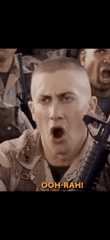 a man in a military uniform is holding a gun and saying ooh-rah