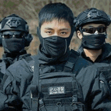 a group of soldiers are wearing masks and helmets .