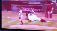 a baseball game is being played in front of a sign for kendsa tires