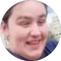 a close up of a person 's face in a circle with a blurry background
