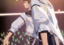 a man with glasses and a white jacket is standing in front of a crowd