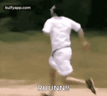 a man in a white shirt is running on a field .