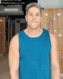 a man wearing a blue tank top is standing in front of lockers with the number 96 on it