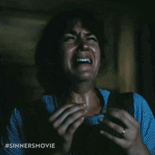 a woman is crying with a #sinnersmovie hashtag