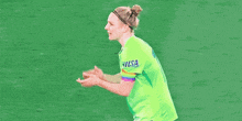 a soccer player wearing a green jersey with visa on the sleeves