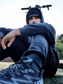 a man wearing a hoodie and a headband with the word multiverse on it