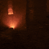 a person in a dark room holding a candle