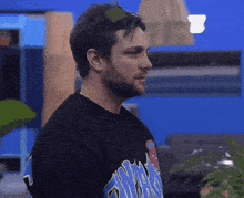a man wearing sunglasses and a black shirt that says ' miami ' on the back