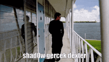 a man is walking down a hallway with the words shadow gerçek dexter written on the bottom