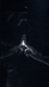 a person 's hand is reaching out towards a screen that says ' ec '