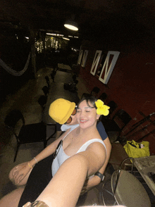 a woman with a yellow flower in her hair is sitting next to a man