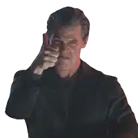 a man in a black suit is pointing his finger at the camera