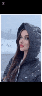 a woman in a black jacket with a hood