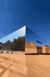 a mirrored building in the middle of a desert with mountains reflected in it