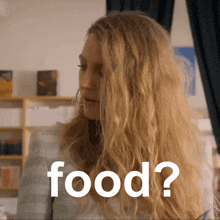 a woman with long blonde hair has the word food written on her face