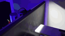 a computer monitor is lit up with a purple light