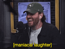 a man wearing a blue jays hat is smiling and says " maniacal laughter "
