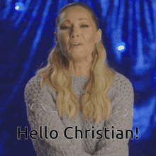 a woman in a grey sweater says " hello christian "