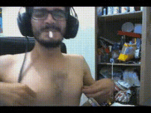 a man without a shirt is wearing headphones
