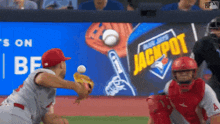 a baseball game is being played in front of a sign that says jackpot
