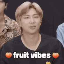 a close up of a man 's face with the words `` fruit vibes '' written above him .