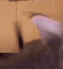 a blurred image of a person 's feet against a brown background