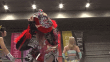 a female wrestler stands in front of a banner that says neo genes