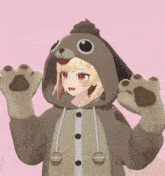a girl is wearing a hoodie that looks like a dog with a poop on her head .