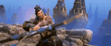a man is holding a sword in a video game while standing in front of a mountain .