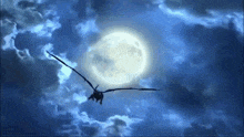 a dragon is flying through a cloudy night sky with a full moon in the background .