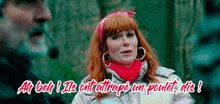 a woman with red hair and hoop earrings is talking to a man with a beard
