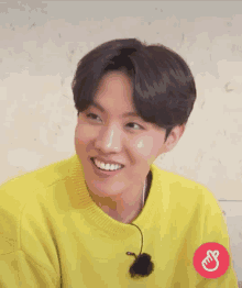 a close up of a person wearing a yellow sweater with chinese writing on it