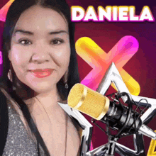 a woman stands in front of a microphone with the name daniela on the top