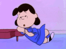 lucy brown from the peanuts cartoon is laying on the floor