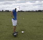 a man is riding a hover board on a golf course .