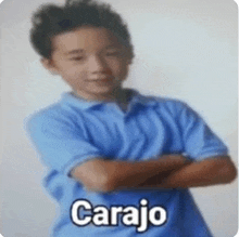 a young boy wearing a blue shirt with the word carajo on it .