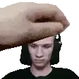 a man wearing headphones is getting a fist bump from a hand .