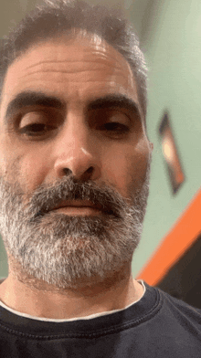 a man with a beard and mustache is wearing a black sweatshirt
