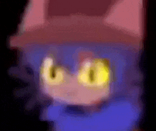a close up of a cat 's face with yellow eyes and a red hat .