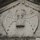 a statue of a bat with wings and a hourglass with pixiz written on the bottom
