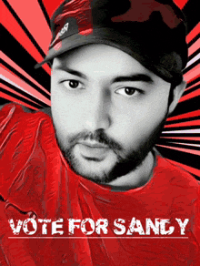 a man wearing a hat and a red shirt with the words vote for sandy on the bottom
