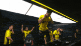 a man wearing a yellow shirt that says " blitz " on it