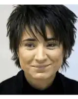 a close up of a woman 's face with a smile on her face
