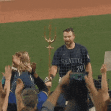 a man in a seattle jersey stands in front of a crowd