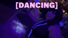 a woman is dancing in front of a sign that says dancing on it
