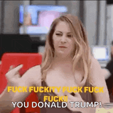 a woman is sitting at a table with a phone in her hand and says `` fuck fuckity fuck fuck fuck you donald trump ! ''