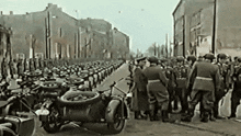 a black and white photo of a parade of soldiers