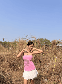 a woman wearing a pink cowboy wanted tank top