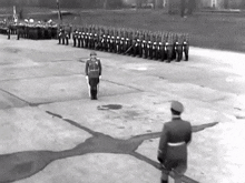 a black and white photo of soldiers marching in a parade